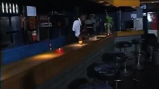 A woman gets caught on the bar by the bartender.