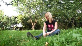 Cute blonde standing on the grass and waiting for a cock