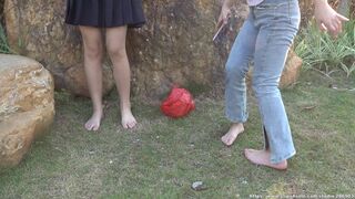 aapary Two Girls Showing Their Bare Feet On The Grass In The Park